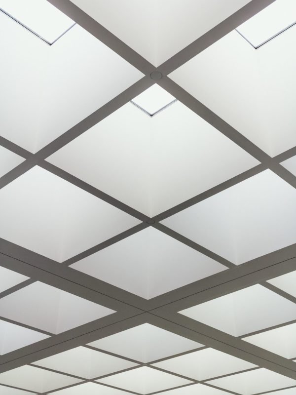 A low angle shot of the ceiling of a building made of bright lighted squares